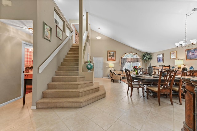 tiled dining area with vaulted ceiling and an inviting chandelier