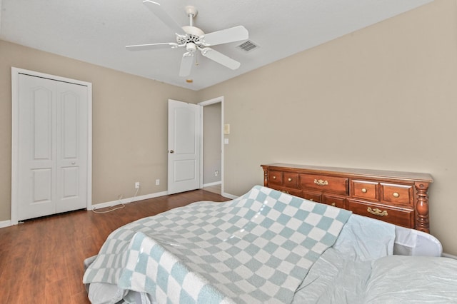 bedroom with ceiling fan, dark hardwood / wood-style flooring, and a closet