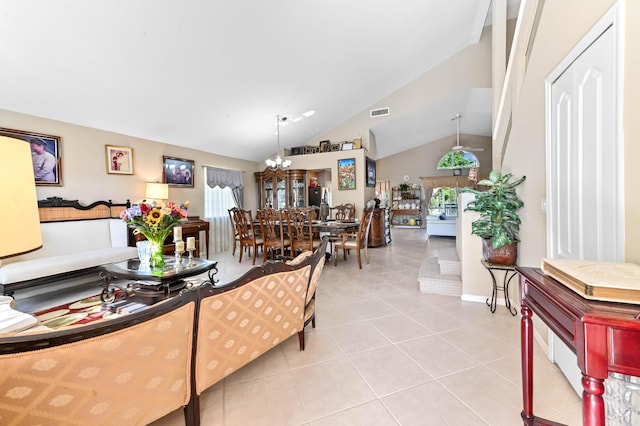 tiled living room with vaulted ceiling and a chandelier