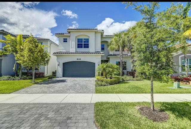 mediterranean / spanish-style house with a front yard and a garage