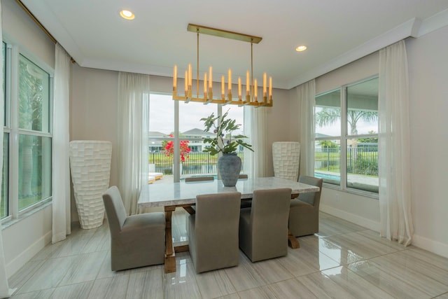 dining area featuring an inviting chandelier and crown molding