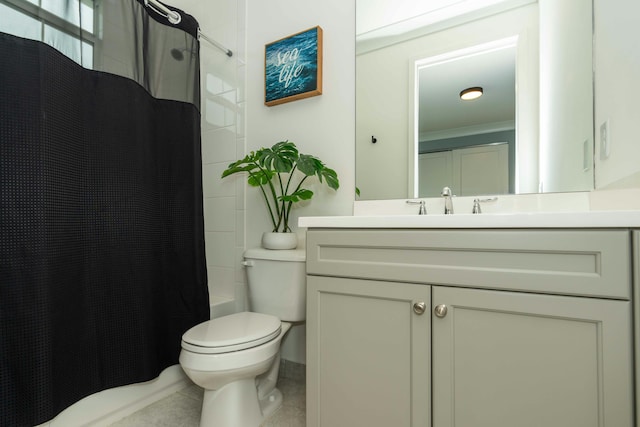 bathroom with toilet, vanity, and crown molding