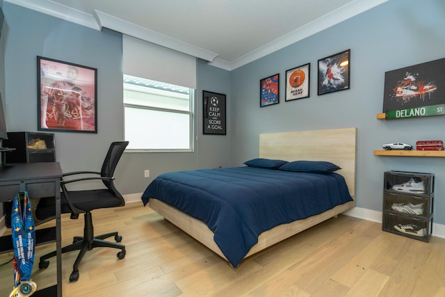 bedroom with light hardwood / wood-style flooring and ornamental molding