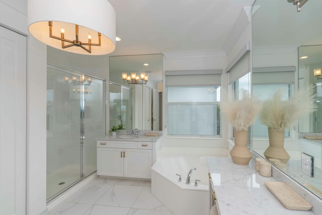 bathroom featuring separate shower and tub, vanity, and a notable chandelier