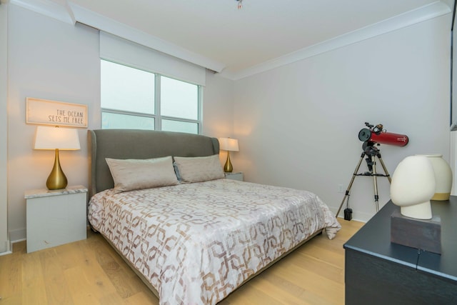 bedroom featuring ornamental molding and hardwood / wood-style floors