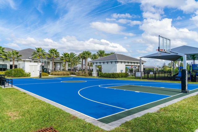 view of sport court with a lawn