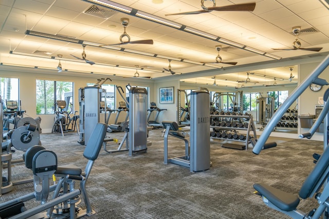 gym featuring ceiling fan and dark carpet