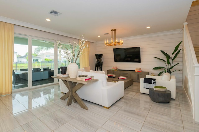 living room with light tile patterned flooring, ornamental molding, an inviting chandelier, and wooden walls