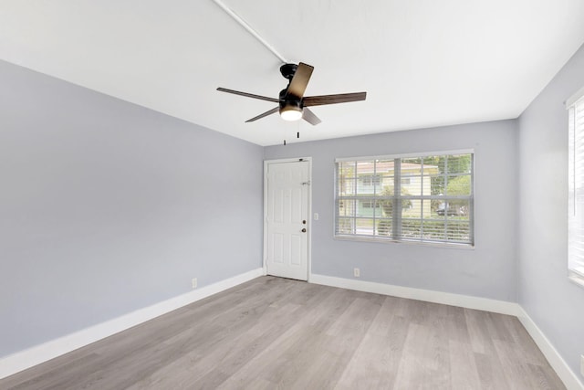 empty room with light wood-type flooring and ceiling fan