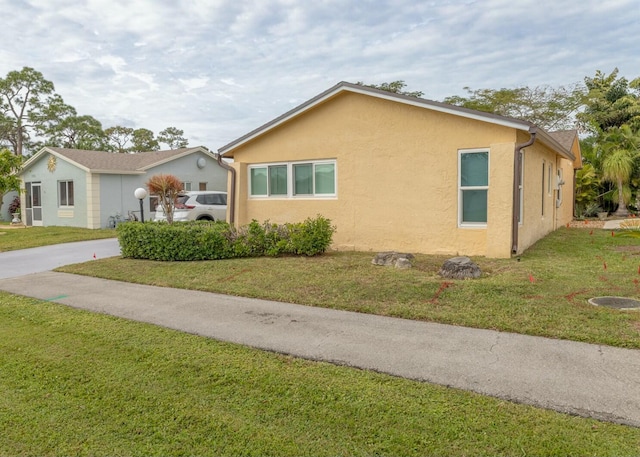 view of home's exterior featuring a yard