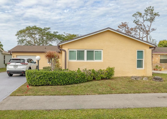 view of property exterior with a yard