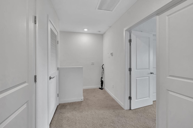 hallway featuring light carpet