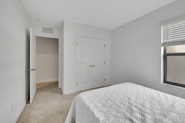 carpeted bedroom featuring a closet