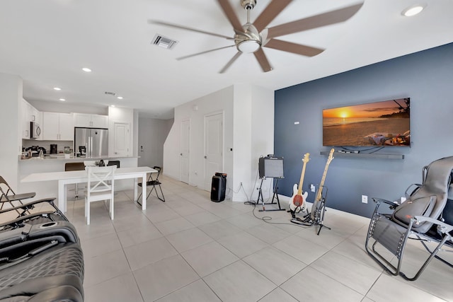 living room featuring light tile patterned flooring and ceiling fan