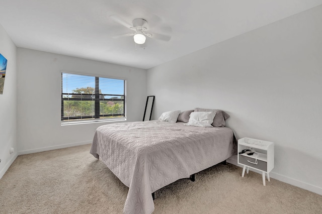 bedroom featuring light colored carpet and ceiling fan