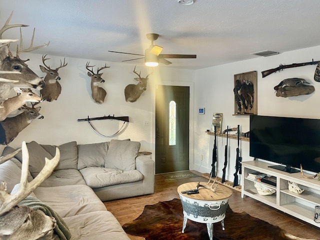 living room with ceiling fan and wood-type flooring