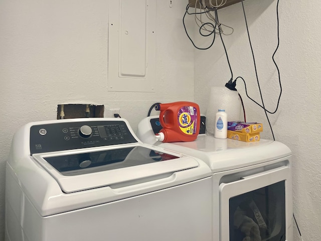 washroom with electric panel and washing machine and clothes dryer