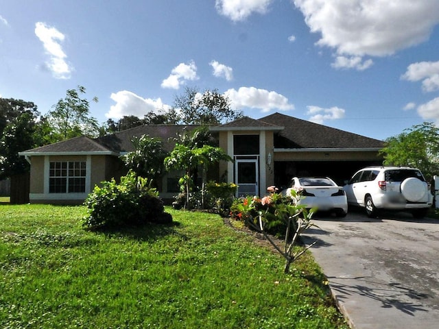 view of front of home featuring a garage and a front lawn