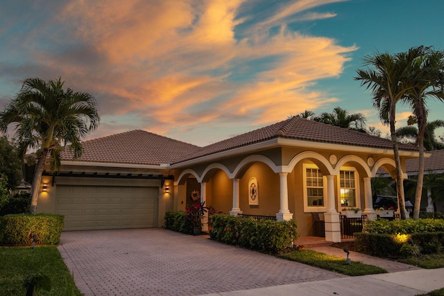 mediterranean / spanish-style home with a garage