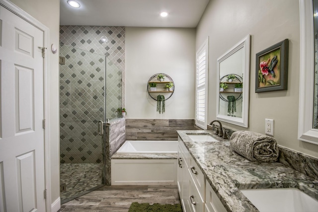 bathroom featuring separate shower and tub, vanity, and hardwood / wood-style flooring