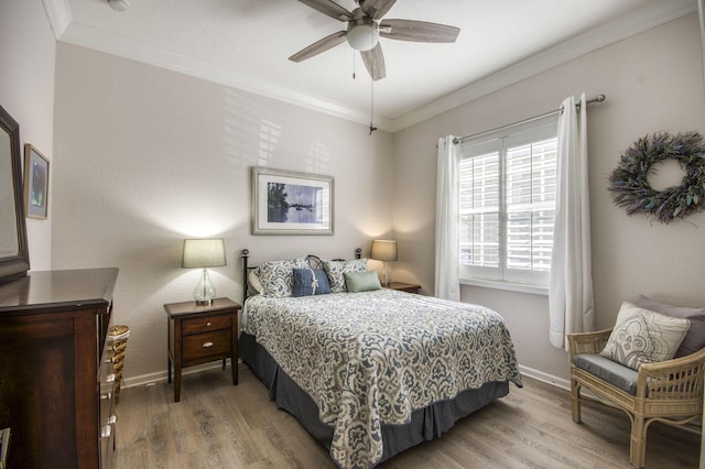 bedroom with ceiling fan, crown molding, and hardwood / wood-style floors