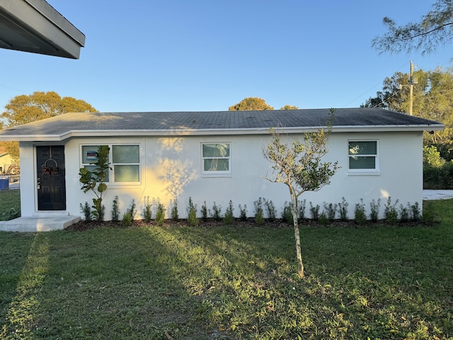 view of side of home featuring a lawn