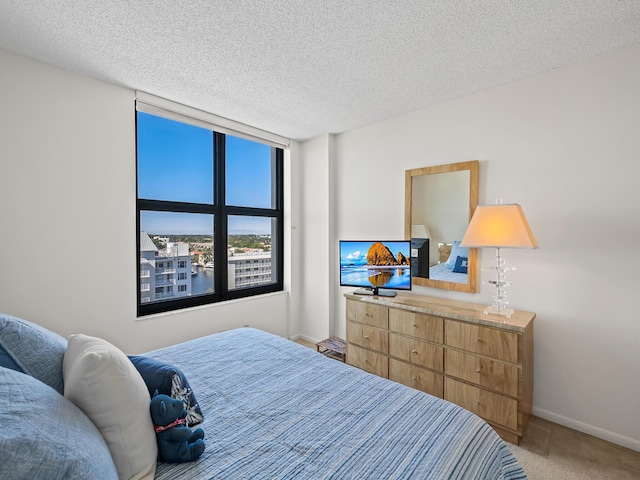 bedroom featuring a textured ceiling and carpet flooring