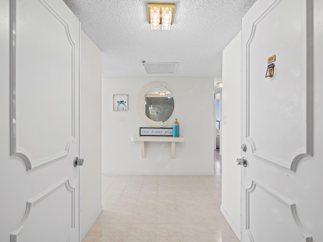 hall with a textured ceiling