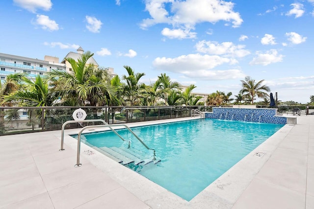 view of pool featuring pool water feature and a patio area