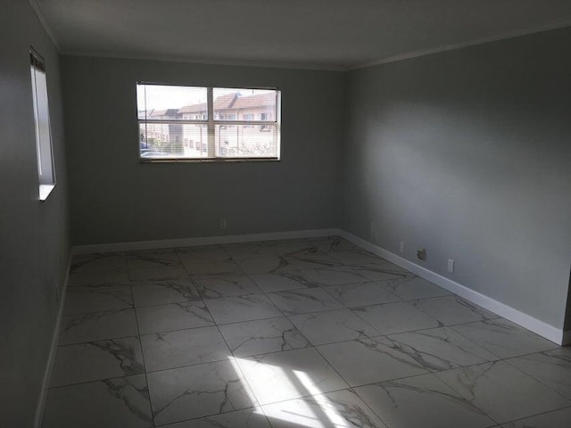 unfurnished room with crown molding