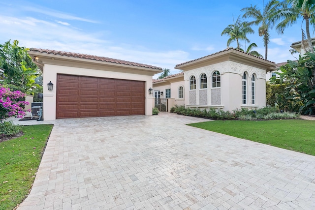 mediterranean / spanish-style house featuring a front yard