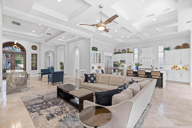 living room with crown molding, french doors, a towering ceiling, and coffered ceiling