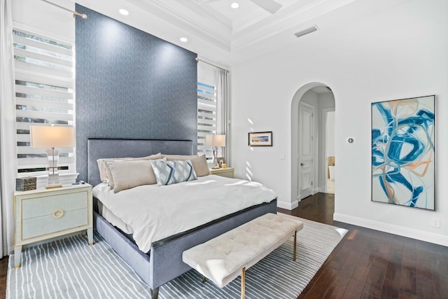 bedroom featuring coffered ceiling, ceiling fan, dark wood-type flooring, crown molding, and beam ceiling