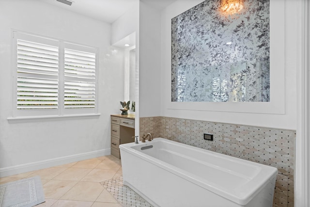 bathroom with a tub, tile patterned flooring, and vanity