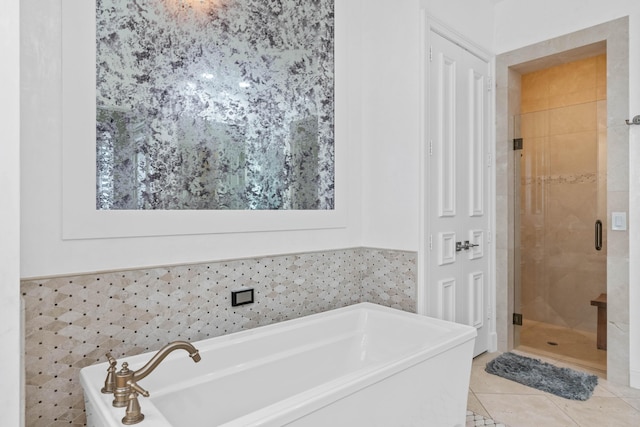 bathroom featuring tile patterned floors, tile walls, and plus walk in shower