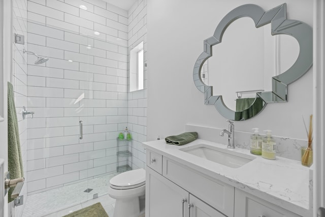 bathroom with tile patterned floors, vanity, toilet, and a shower with door