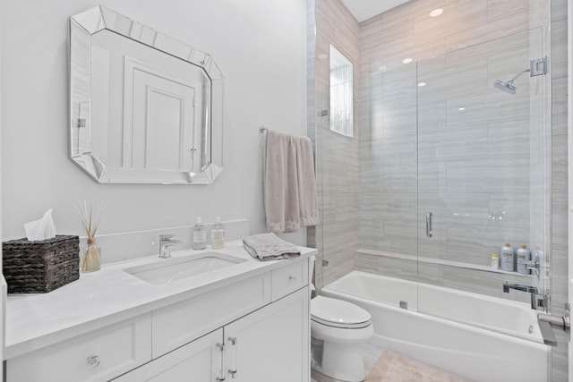 full bathroom with vanity, toilet, and enclosed tub / shower combo