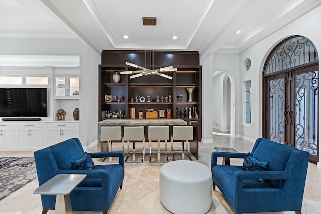 interior space with french doors, white cabinets, crown molding, built in features, and a tray ceiling