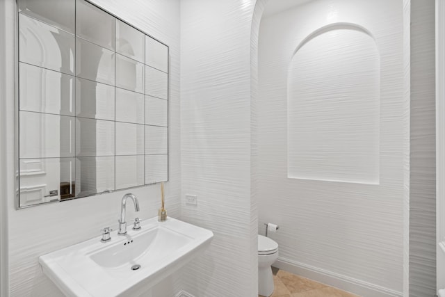 bathroom featuring tile patterned flooring, toilet, and sink