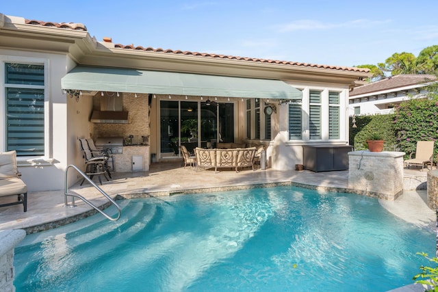 view of swimming pool featuring area for grilling, a grill, and a patio area