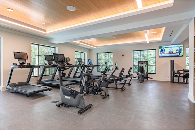 workout area with a tray ceiling and wooden ceiling