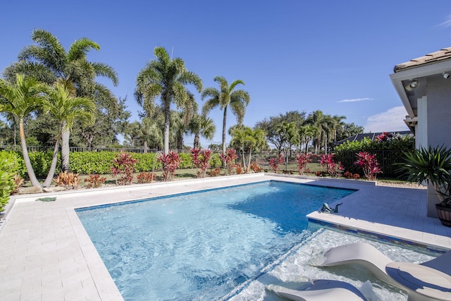 view of pool with a jacuzzi