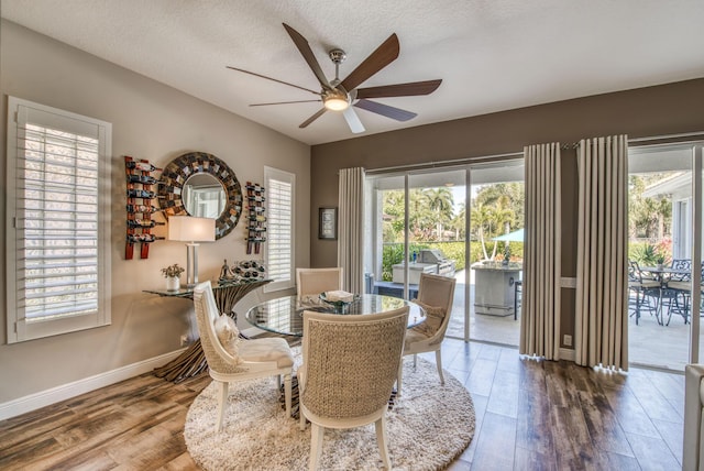 dining space with ceiling fan, a textured ceiling, and hardwood / wood-style flooring