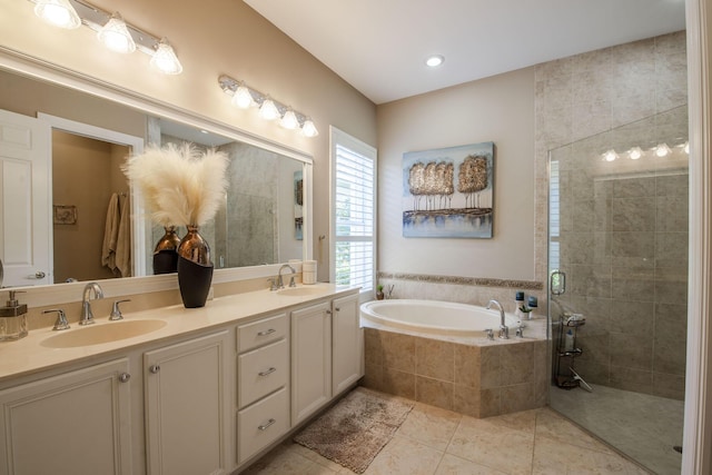 bathroom with tile patterned floors, vanity, and plus walk in shower