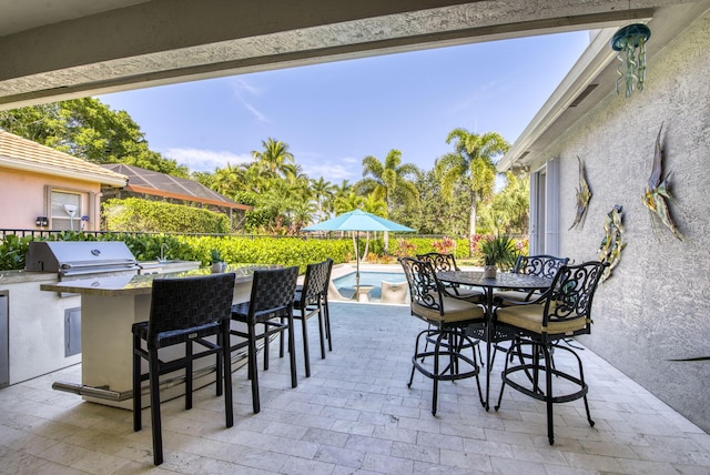 view of patio / terrace featuring a fenced in pool, a grill, area for grilling, and a bar