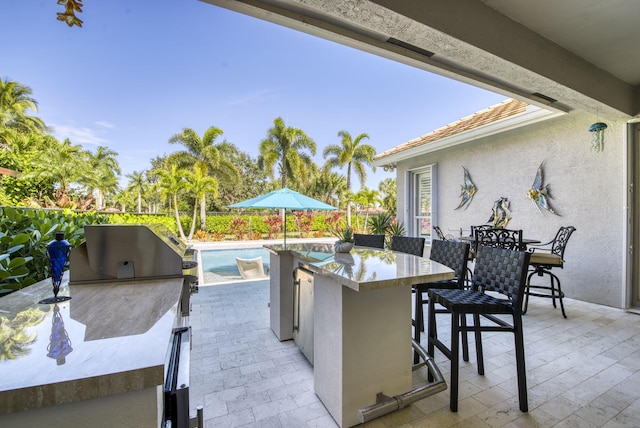 view of patio / terrace featuring a grill, area for grilling, and exterior bar