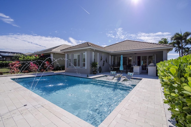 view of pool featuring pool water feature and a patio area