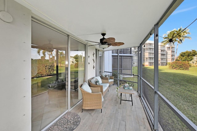 unfurnished sunroom with ceiling fan