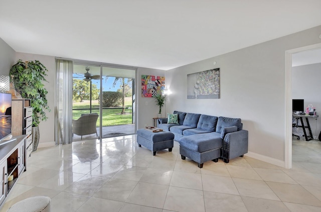 living room with light tile patterned floors, floor to ceiling windows, and ceiling fan