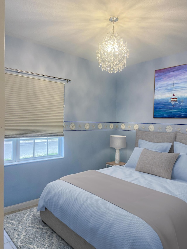 tiled bedroom with a chandelier